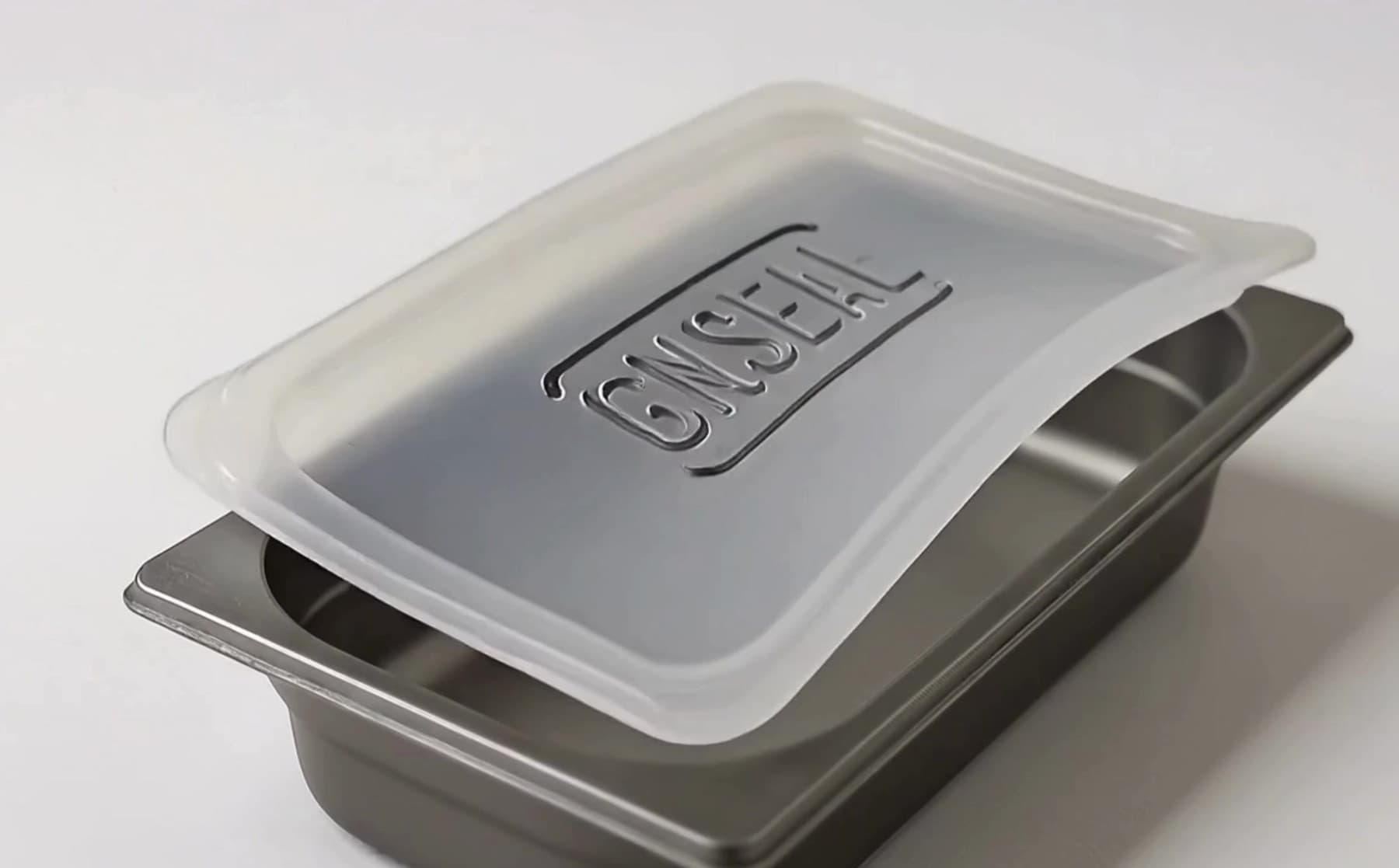 A GNSeal cover draping onto a gastronorm pan, showing how the silicone flexes